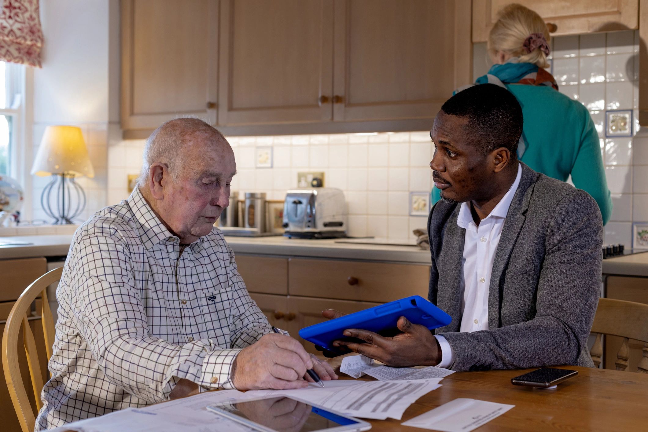 Advisor speaking with older adults at a table