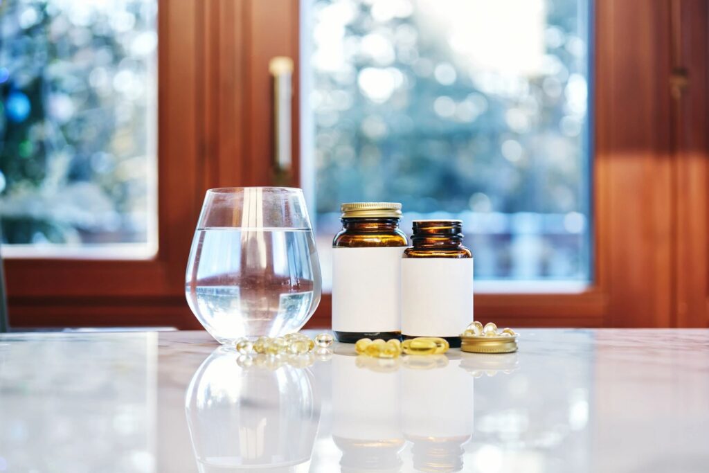 Supplement bottles, water glass, and vitamins for daily health