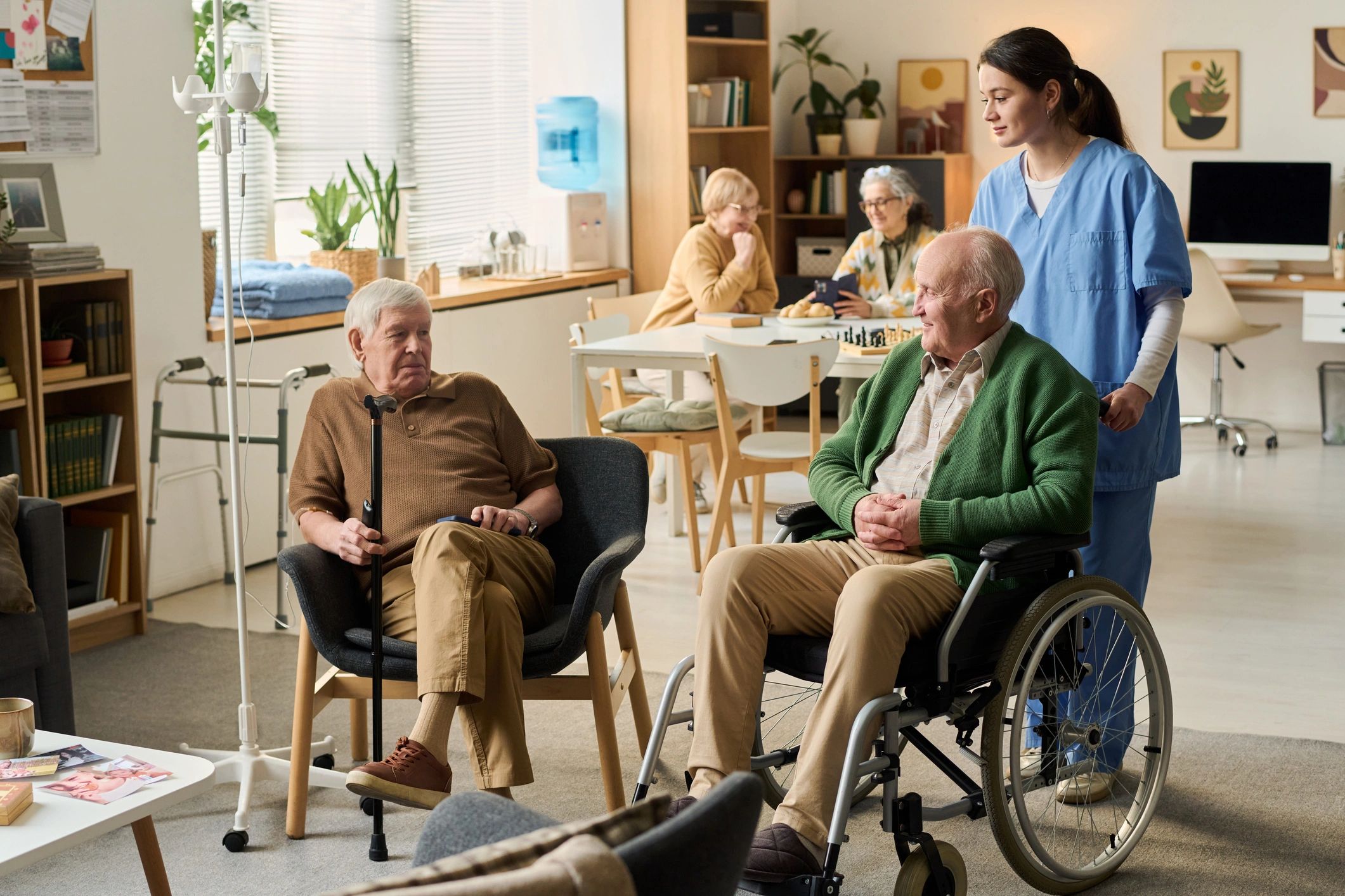 Senior men receiving care support in a common area