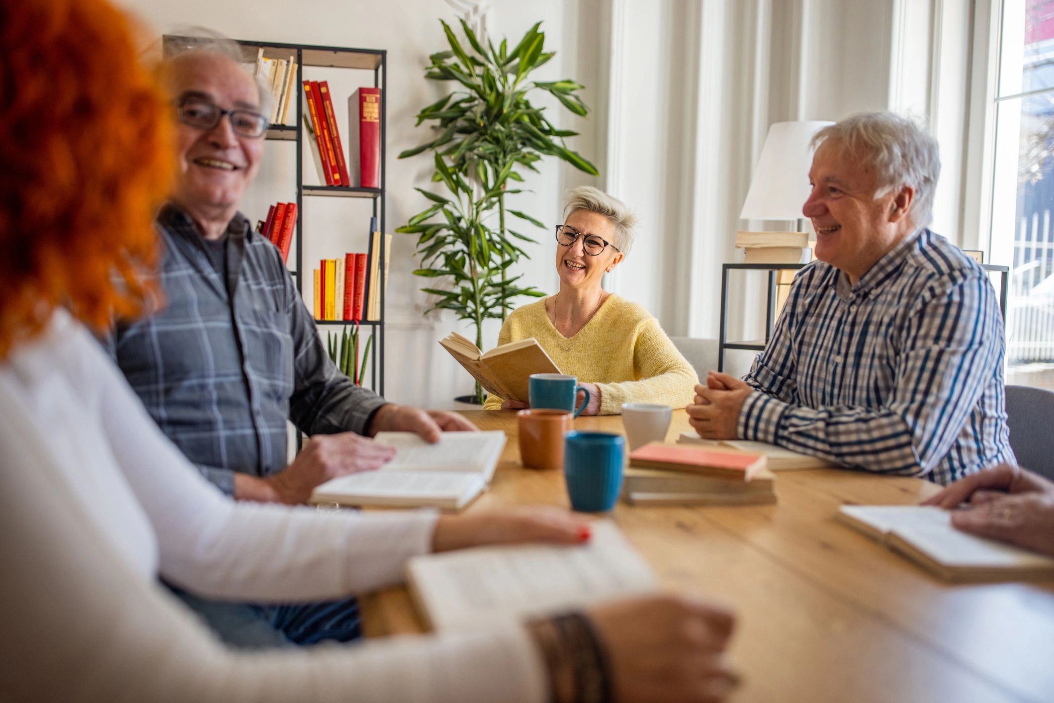 Older adults reading together at home